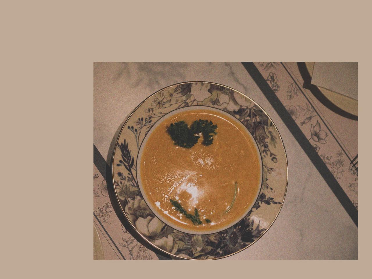 Creamy Pumpkin Soup in a Ceramic Soup Bowl within a Calm Winter Table Setting