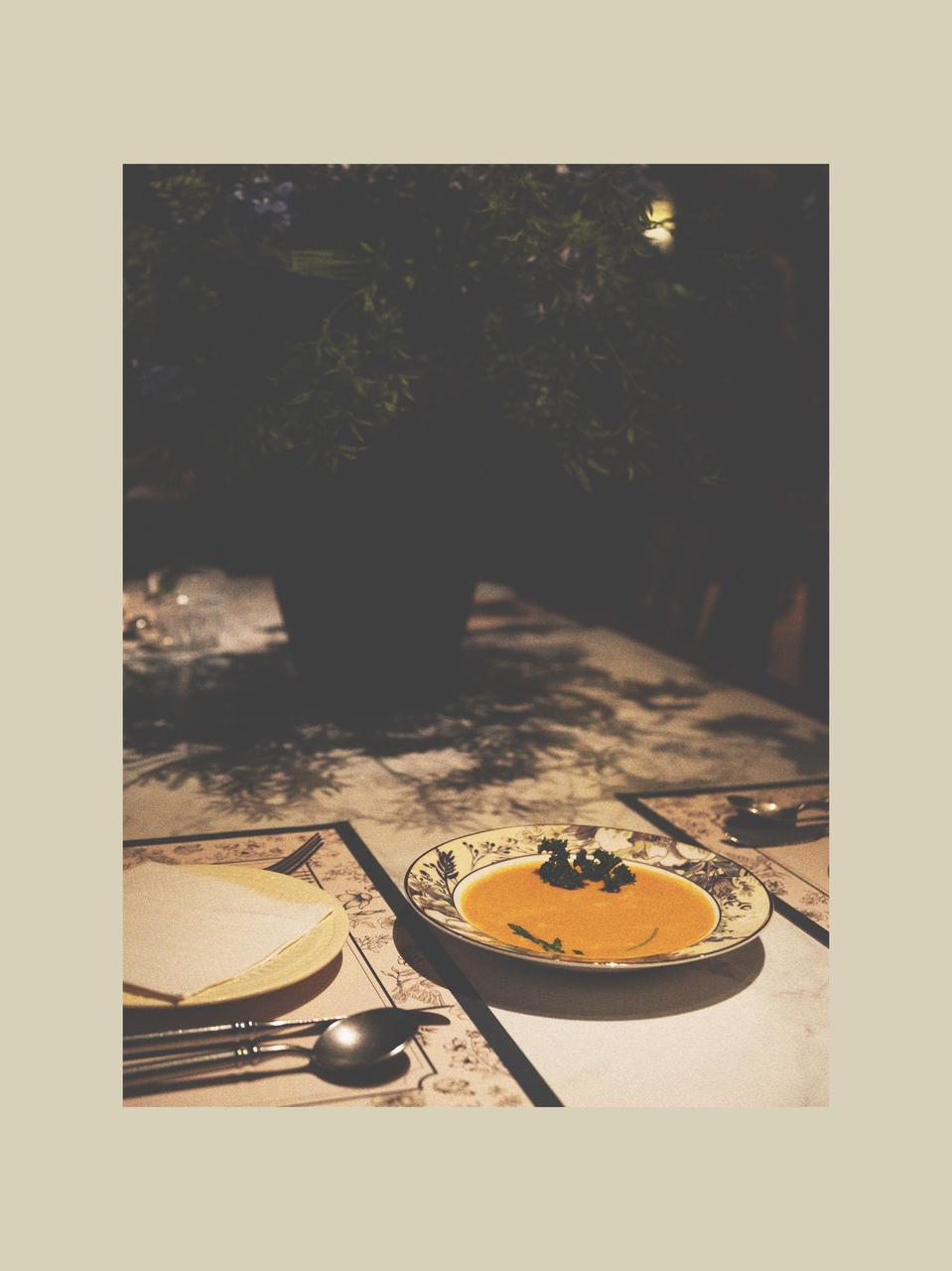 Creamy Pumpkin Soup in a Ceramic Soup Bowl within a Calm Winter Table Setting