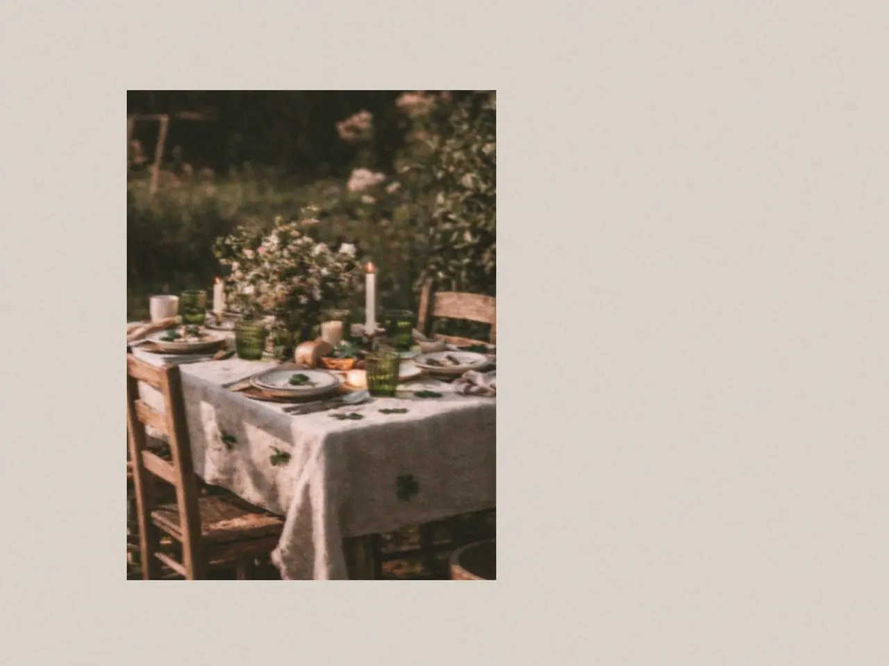Rustic outdoor dining table with green glassware, ceramic plates, candles, and subtle St. Patrick’s Day accessories creating a warm garden table setting.