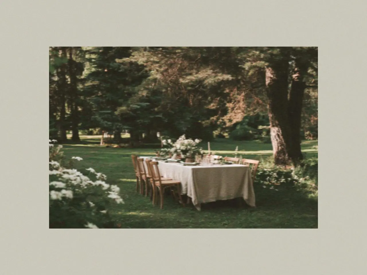 Outdoor green garden dining table decorated with ceramic plates, crockery tableware, and St. Patrick’s Day accessories creating an elegant decoration for the table for a spring gathering.