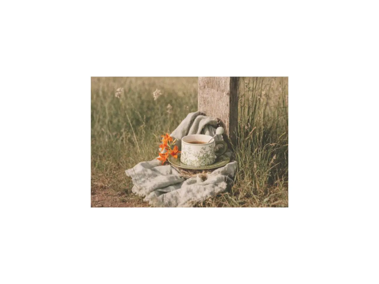 lily of the valley breakfast cup set with spoon placed on a cloth in a quiet green garden during early springtime